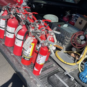 Truck bed loaded with serviced fire extinguishers